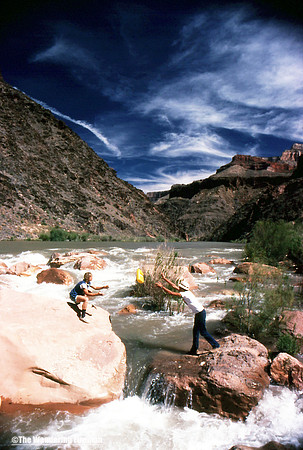 Dan tosses a jug to Rich across the Colorado River in the Grand Canyon