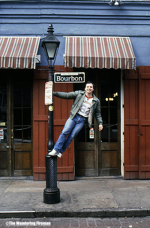 Holding onto the Bourbon Street sign in New Orleans Louisiana