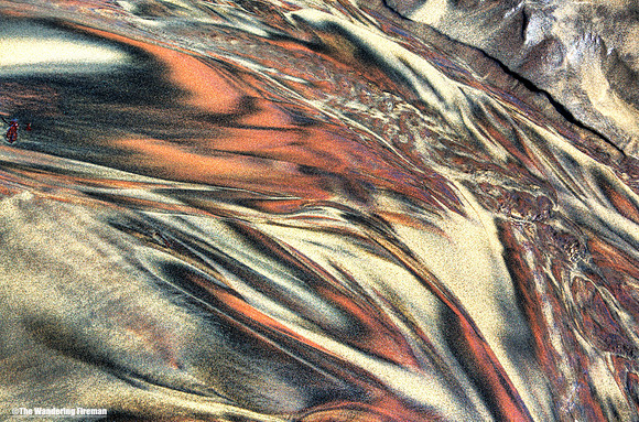 Graphic water rivulet through sand on a beach