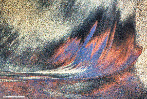 Graphic water rivulets through a sandy beach