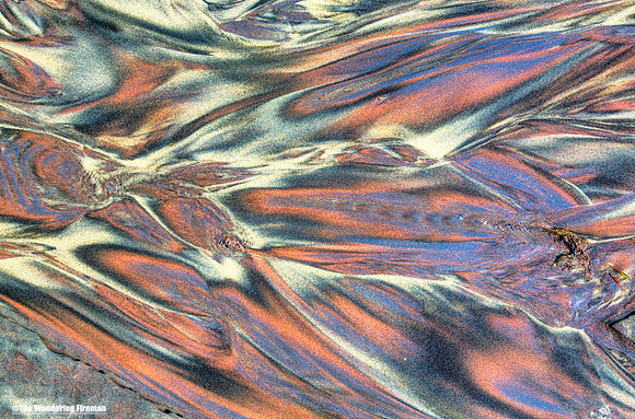 Graphic water rivulets through sand on a beach