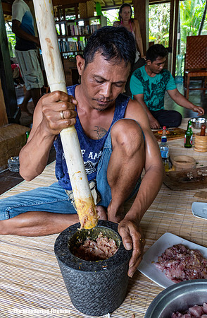 Pounding the meat with spice for a traditional Balinese dinner